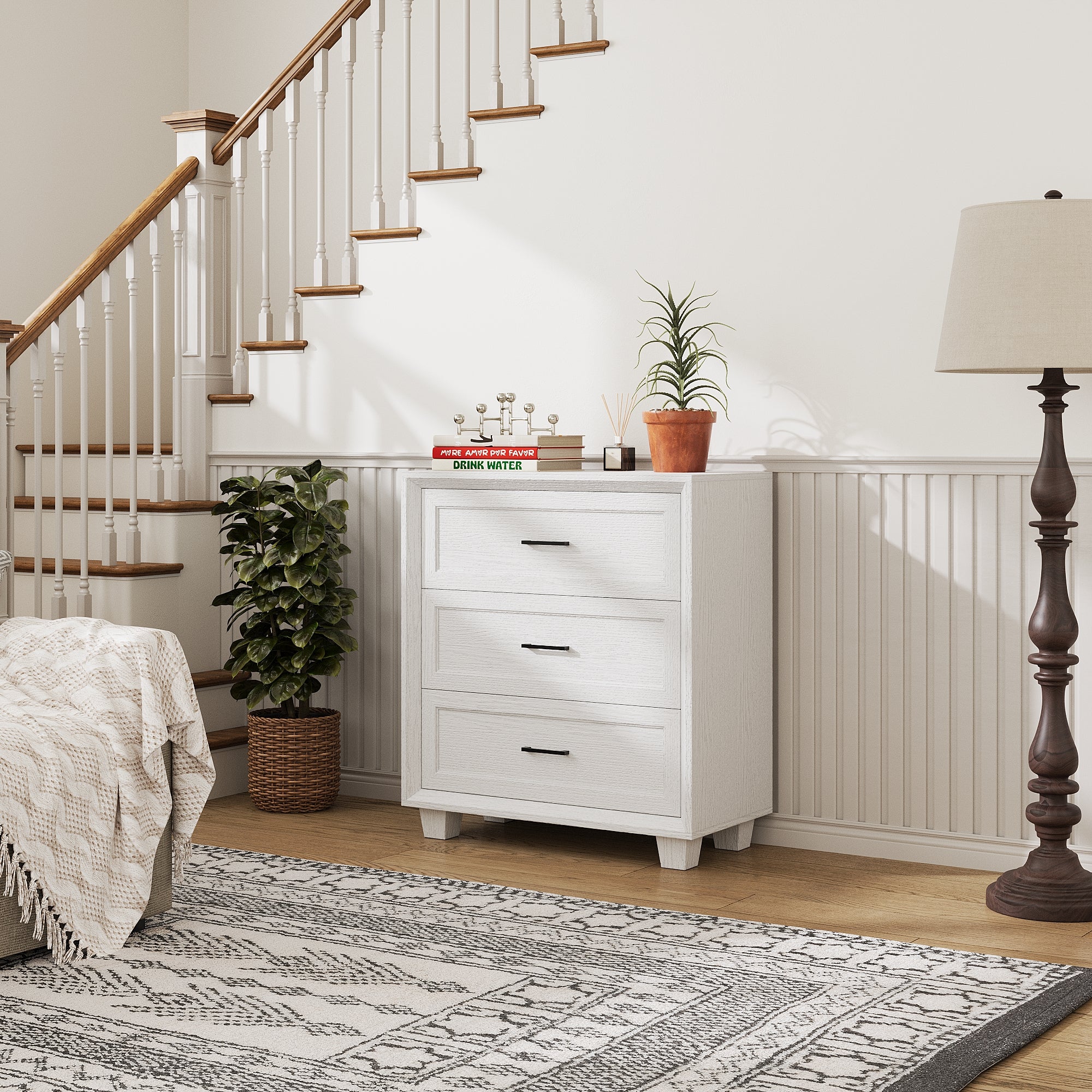 White 3-drawer nightstand with raised panel fronts and black handles