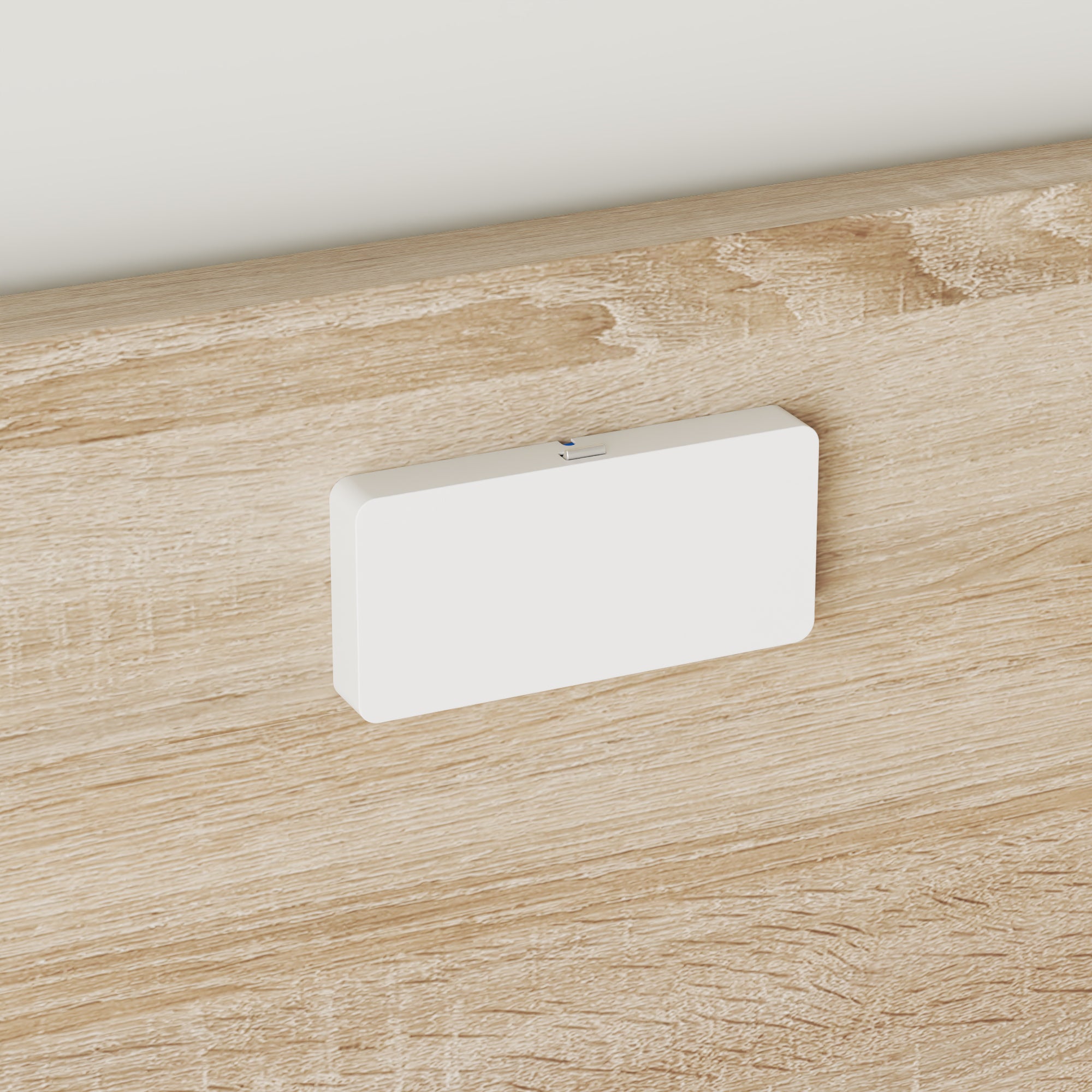 White rectangular object on a wooden surface