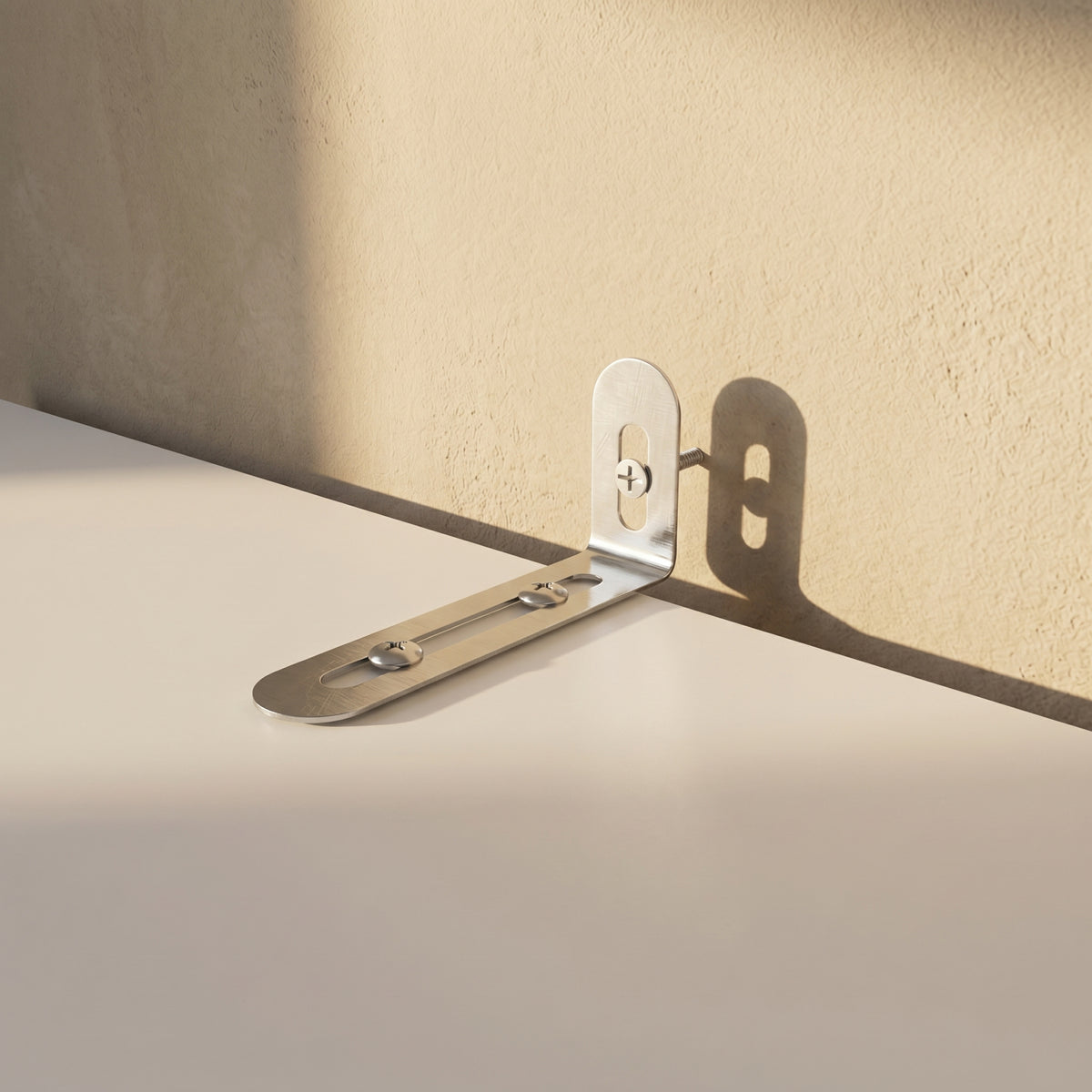 Metal bracket on a beige wall and white surface