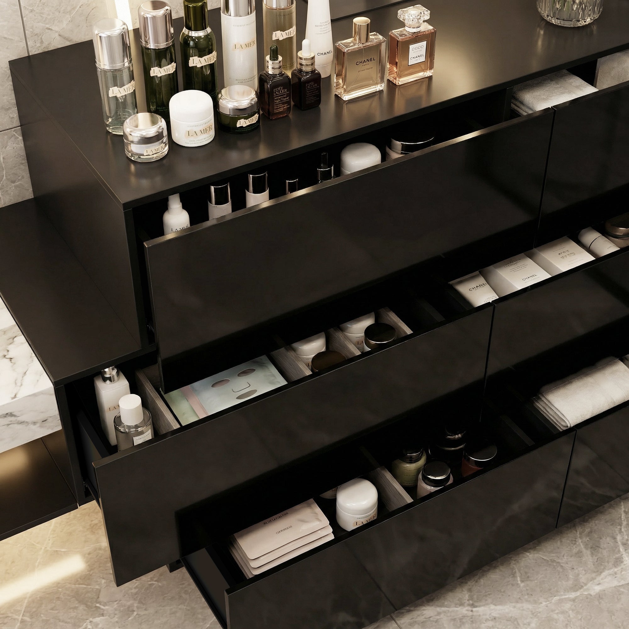 Black high-gloss dresser with wide drawers and vanity mirror setup