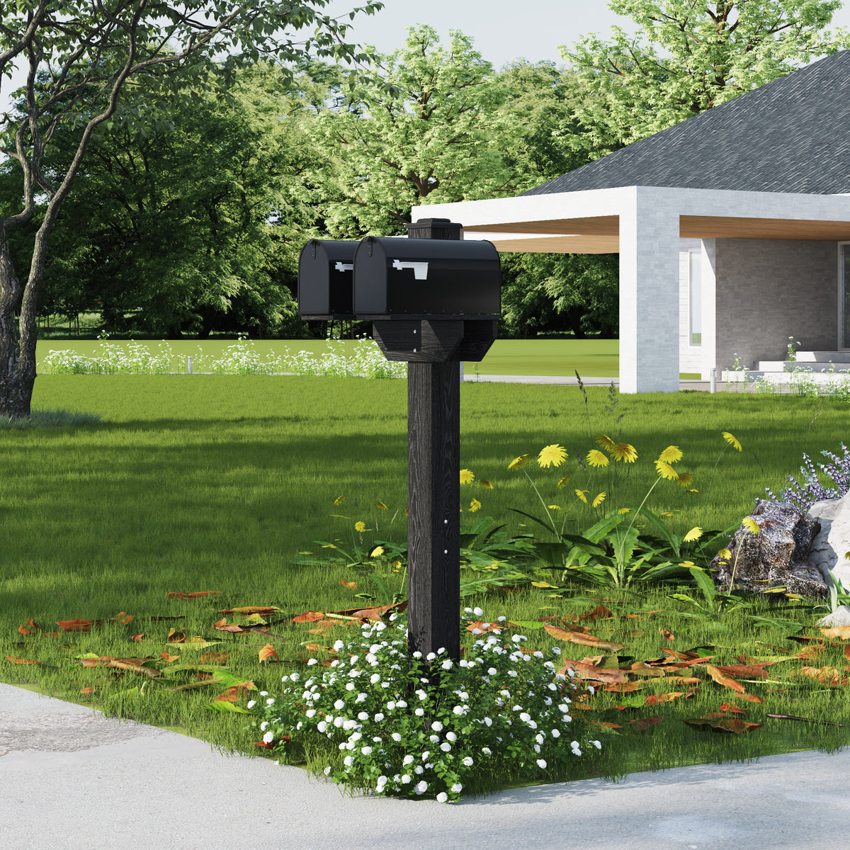 Black mailbox on a post in a garden with a house in the background
