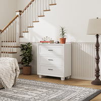 White 3-drawer nightstand with raised panel fronts and black handles