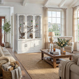 Living room with a large window, white cabinet, and wooden coffee table.