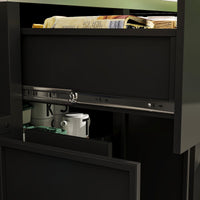 Black kitchen cabinet with open door revealing kitchen items.