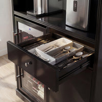 Open drawer with cutlery in a kitchen setting