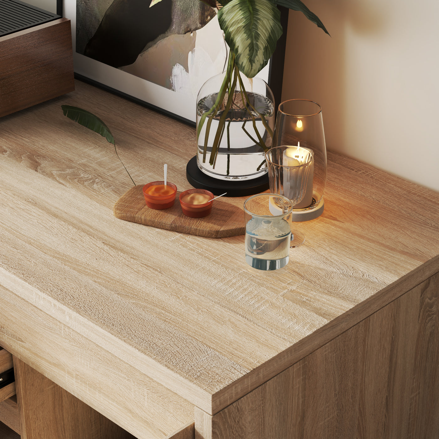 Wooden surface with a candle, small plant, and decorative items