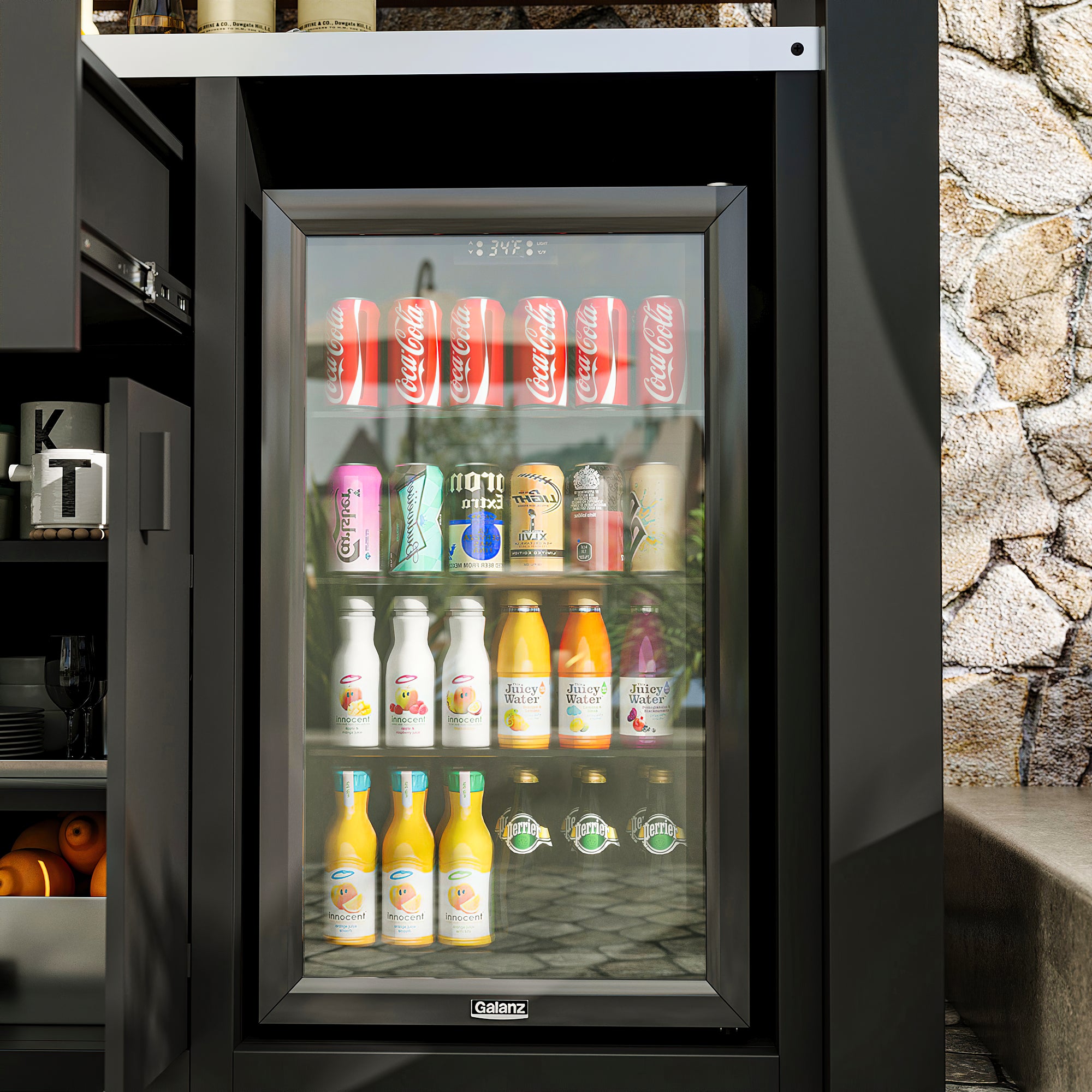 Small refrigerator with glass door displaying various drinks against a stone wall background