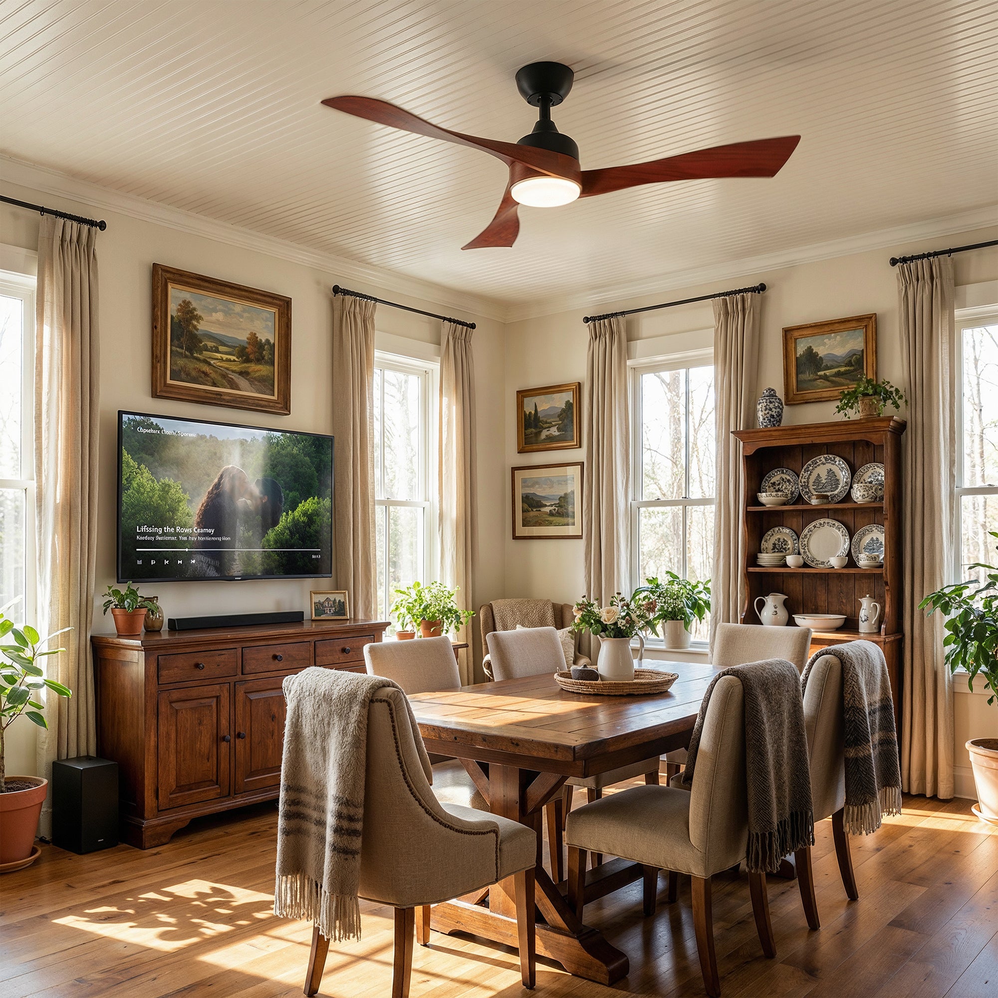 Dining room with wooden table, chairs, and a television on a wooden cabinet.