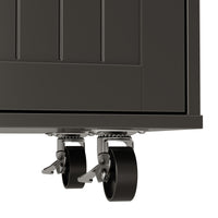 Black kitchen island with wood top, drawers, cabinet doors, towel bar, and wheels
