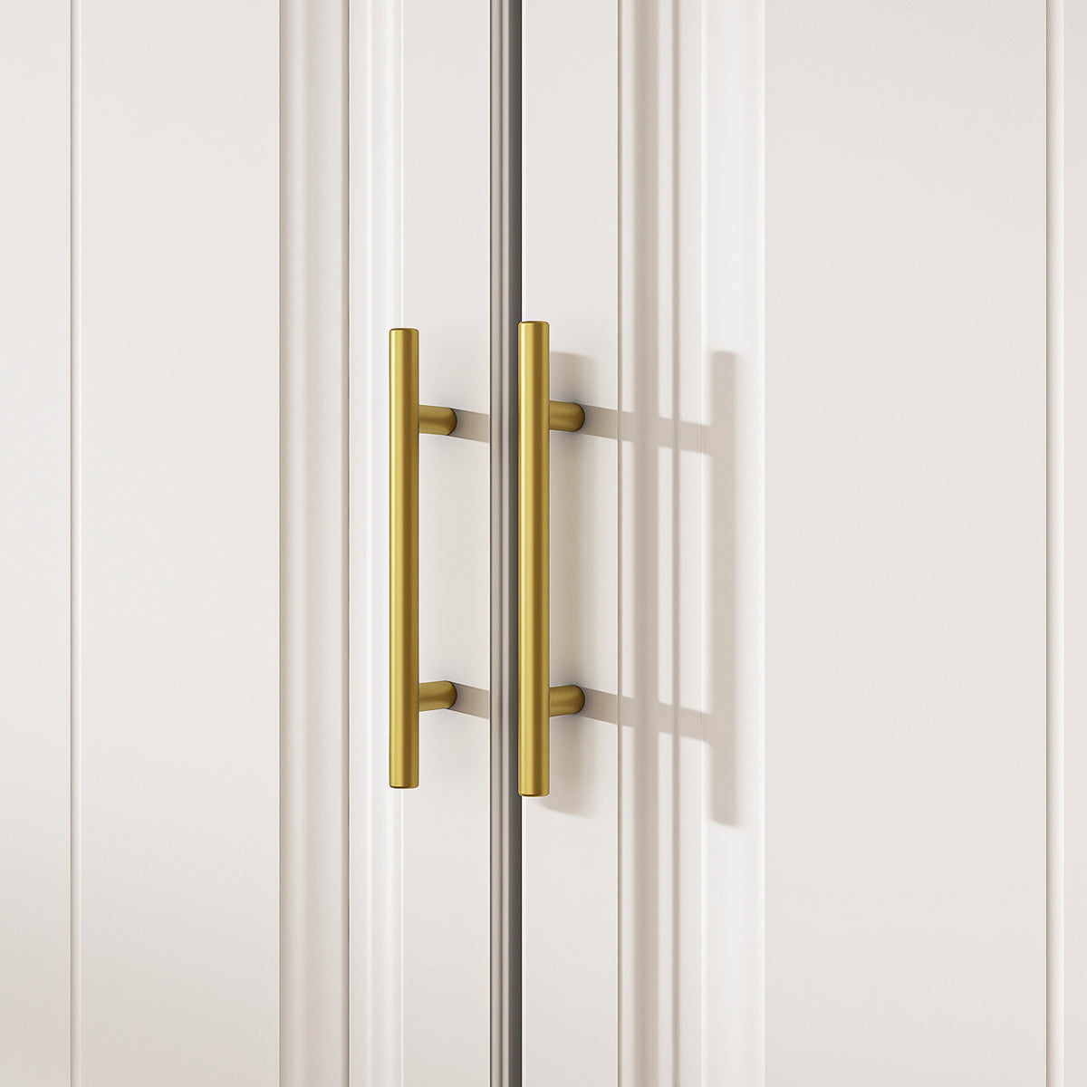 White wardrobe with gold handles in a modern bedroom setting