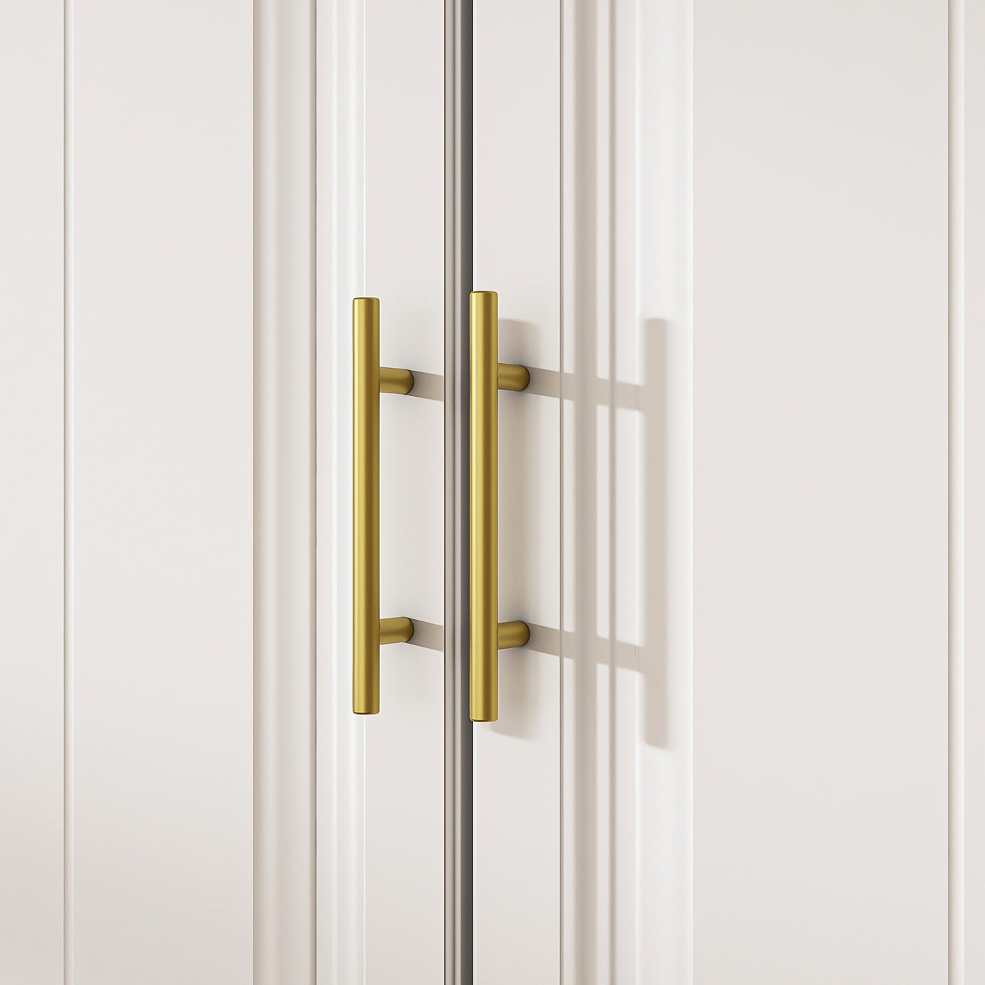 White wardrobe with gold handles in a modern bedroom setting