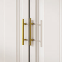 White wardrobe with gold handles in a modern bedroom setting