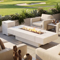 Outdoor patio setting with fire pit table and chairs near a golf course