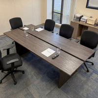 Brown wood writing desk with cable management