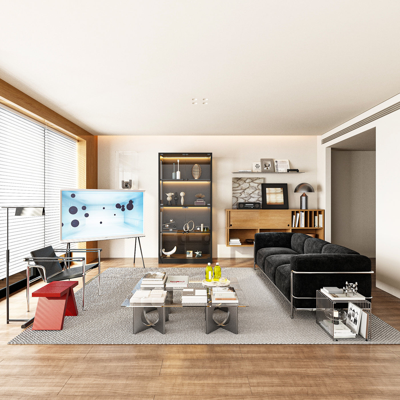 Modern living room with a black sofa, coffee table, and decorative items.