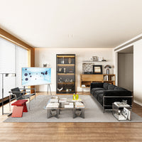Modern living room with a black sofa, coffee table, and decorative items.