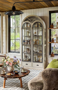 Arched display cabinet with glass doors and drawers