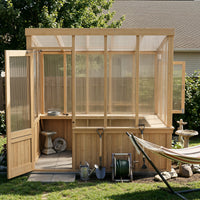 Wooden greenhouse with open doors, tools inside, and a hammock outside.