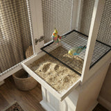 Two colorful parakeets in a birdcage with a wooden base.