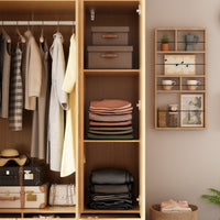 Closet with wooden shelves containing clothes, boxes, and decorative items.