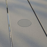 Close-up of a metallic surface with a circular cutout