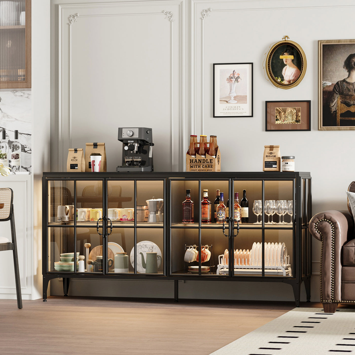 Glass display cabinet with various items in a room with a sofa and wall art.