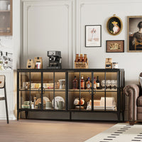 Glass display cabinet with various items in a room with a sofa and wall art.