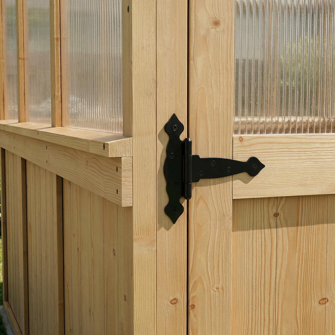 Close-up of a wooden greenhouse door with a black metal hinge.