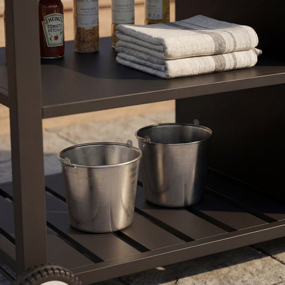 Black outdoor kitchen island cart with side shelf, storage cabinet, sink, and wheels