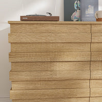 Wooden dresser with a record player on top against a white wall