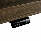 Dark wood standing desk with electric height adjustment and control panel