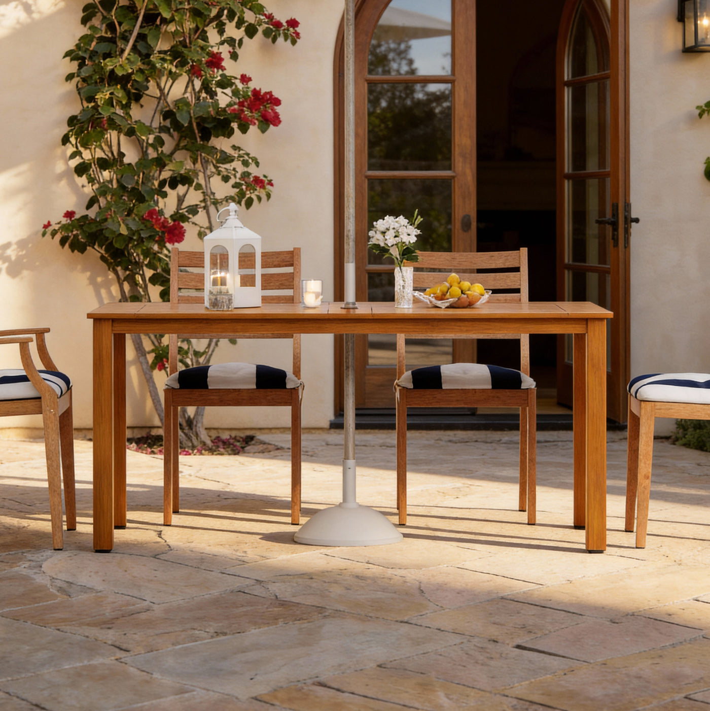 Outdoor patio set with wooden table and chairs on a stone patio
