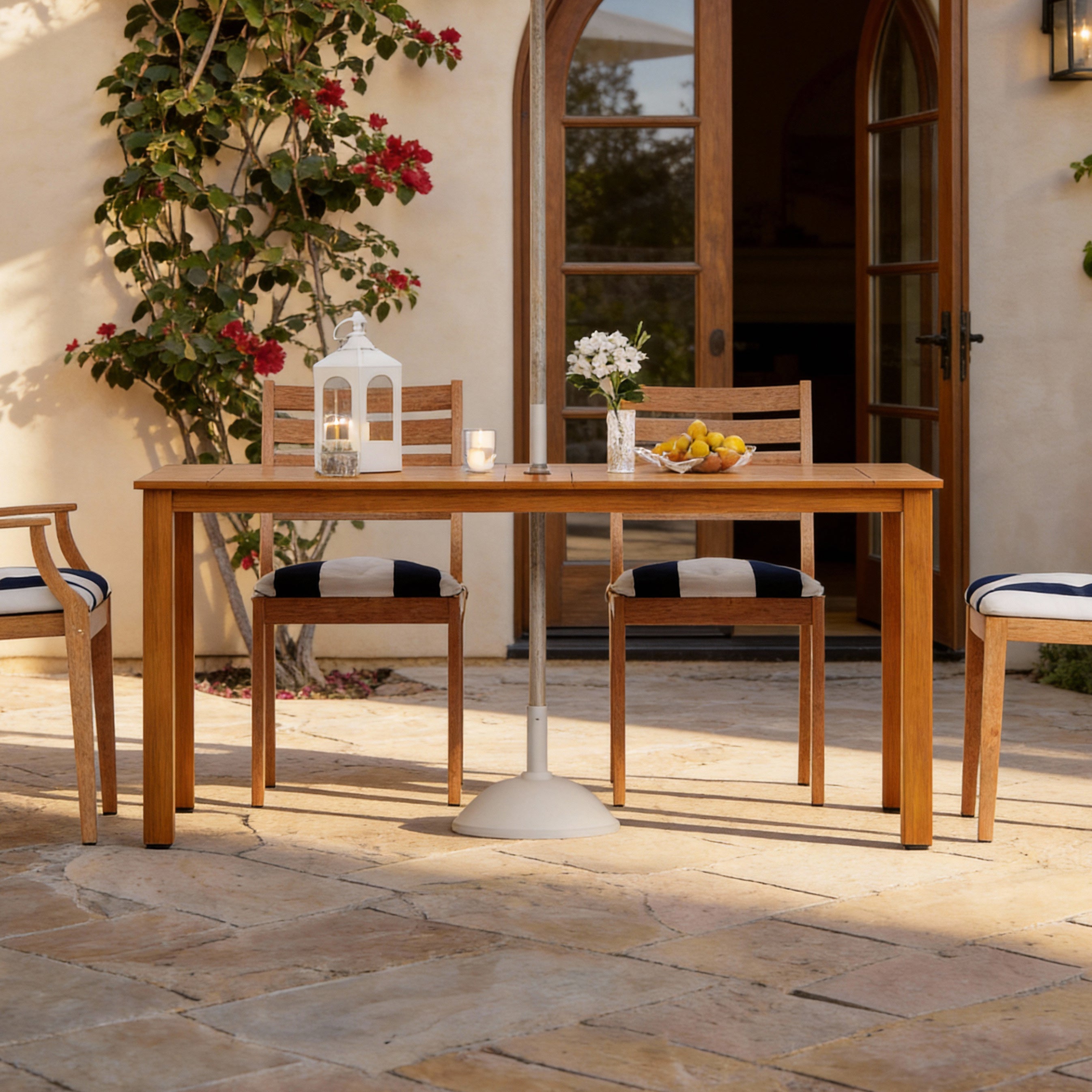 Outdoor patio set with wooden table and chairs on a stone patio