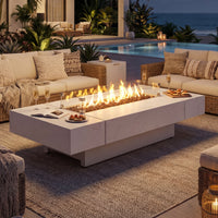 Outdoor patio with fire pit table, couches, and ocean view