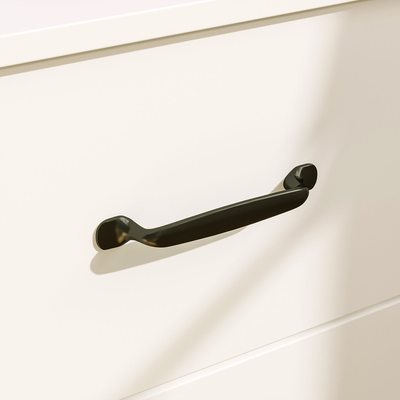 Black handle on a white cabinet door