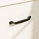 Black handle on a white cabinet door