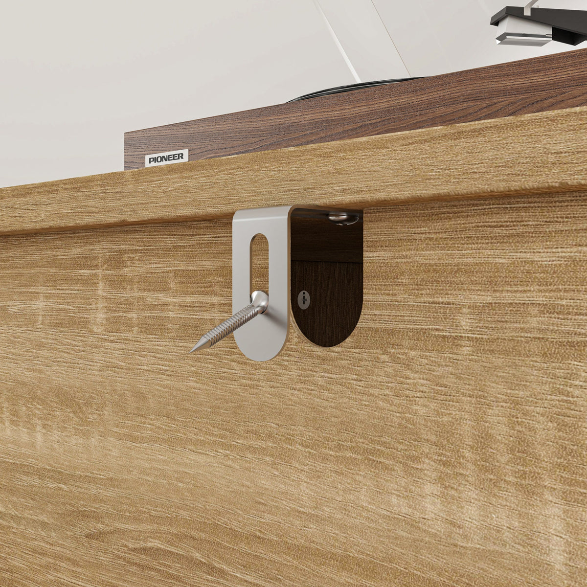 Wooden surface with a metal bracket and screw, featuring the Pioneer logo