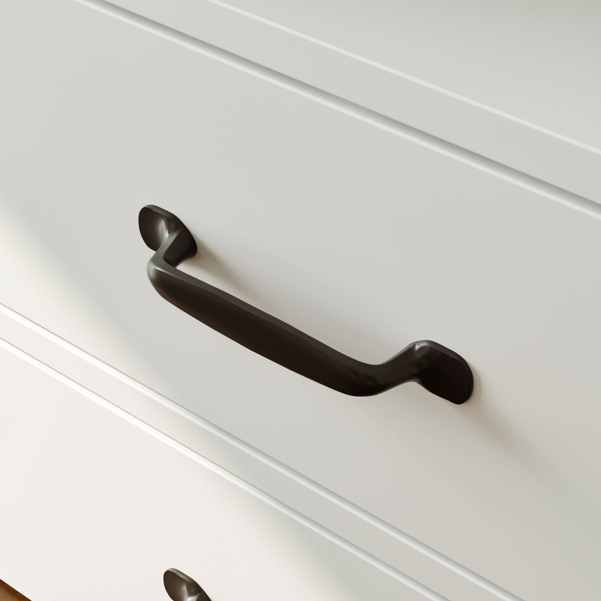 Black cabinet handle on a white drawer
