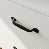 Black cabinet handle on a white drawer