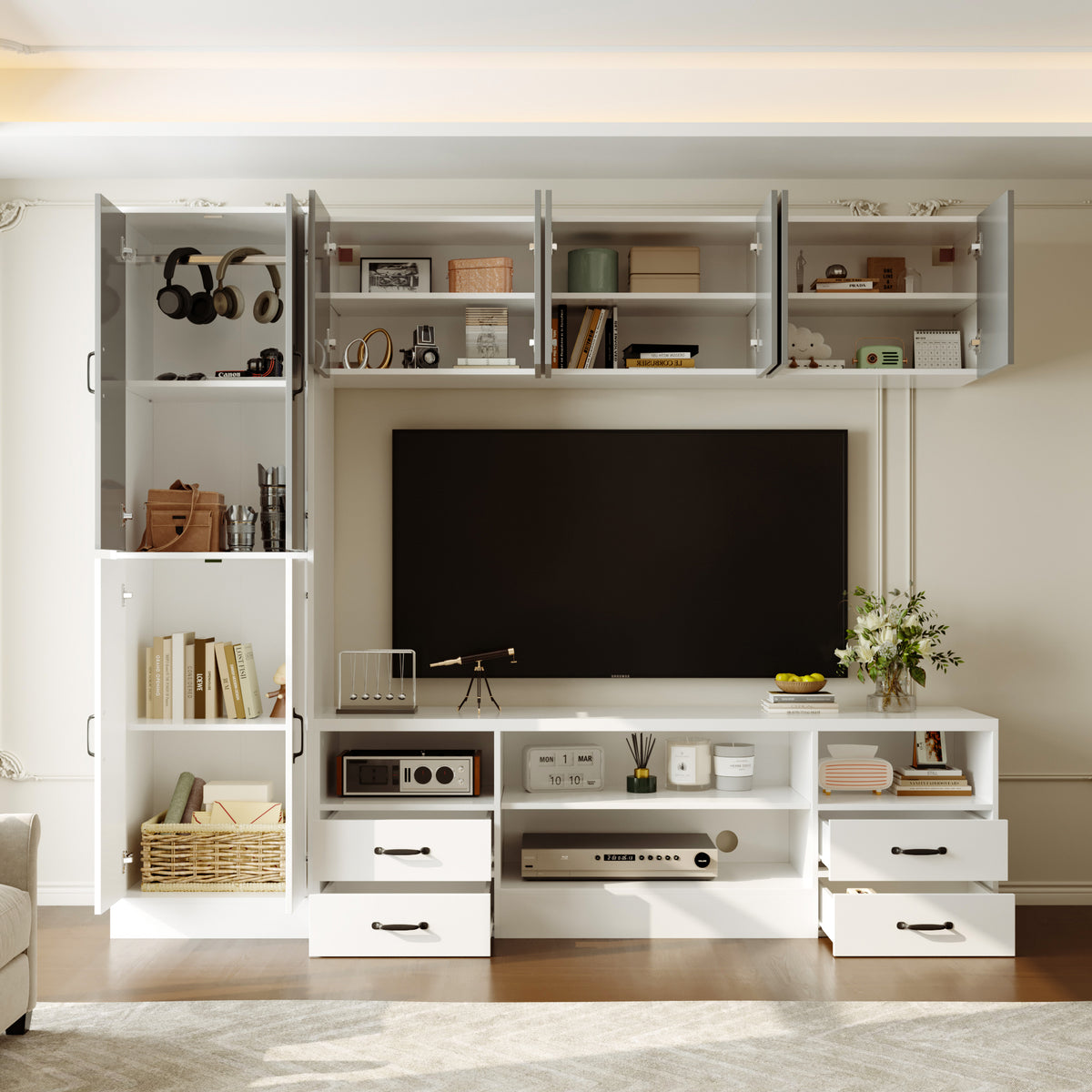 Modern living room with white entertainment console, TV, and shelves.