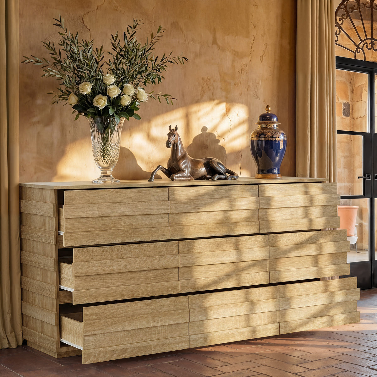 Wooden dresser with decorative items against a textured wall
