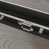 Metal track lighting fixture on a wooden surface
