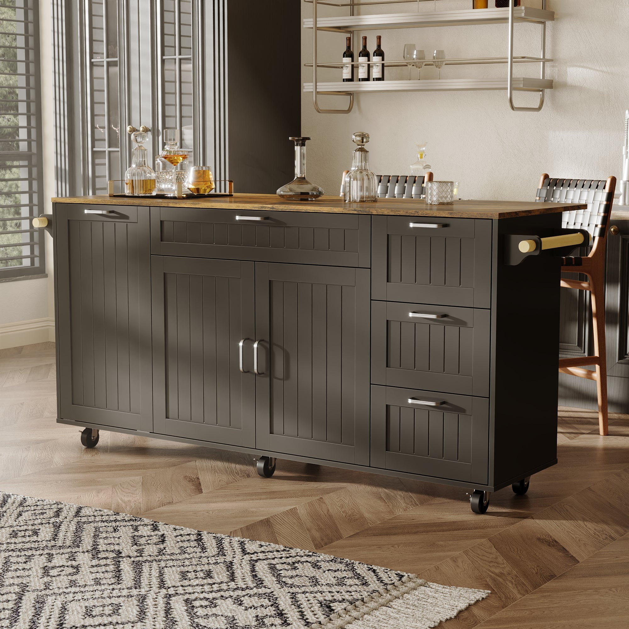 Black kitchen island with wood top, drawers, cabinet doors, towel bar, and wheels