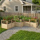 Wooden raised garden beds with plants in front of a house