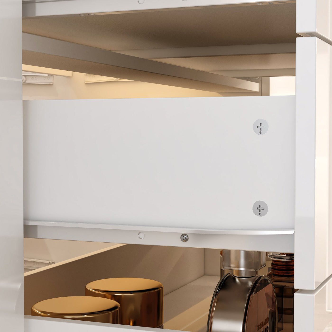 Close-up of a kitchen cabinet with a white drawer and metallic handles.