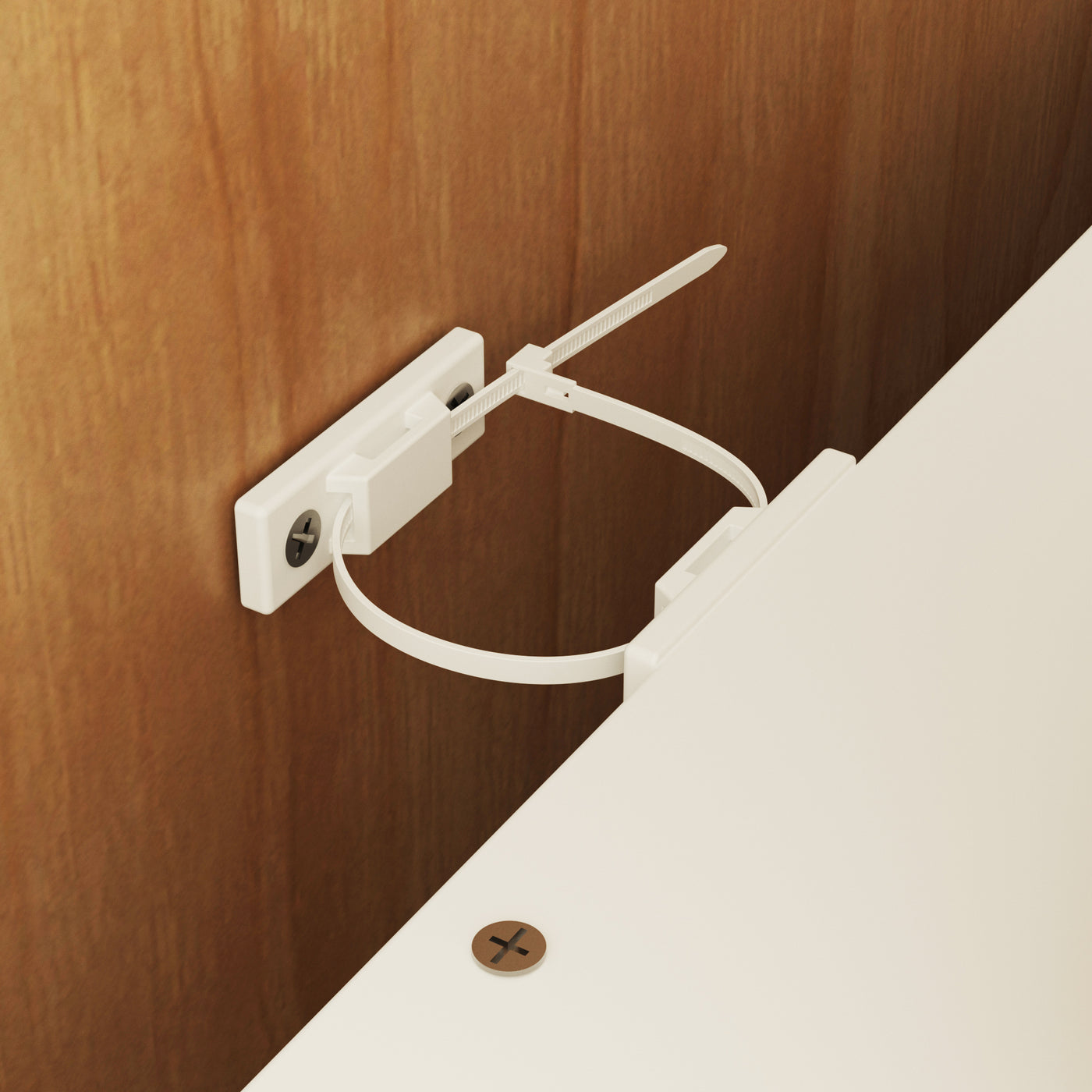 White magnetic clip on a wooden surface with a white background