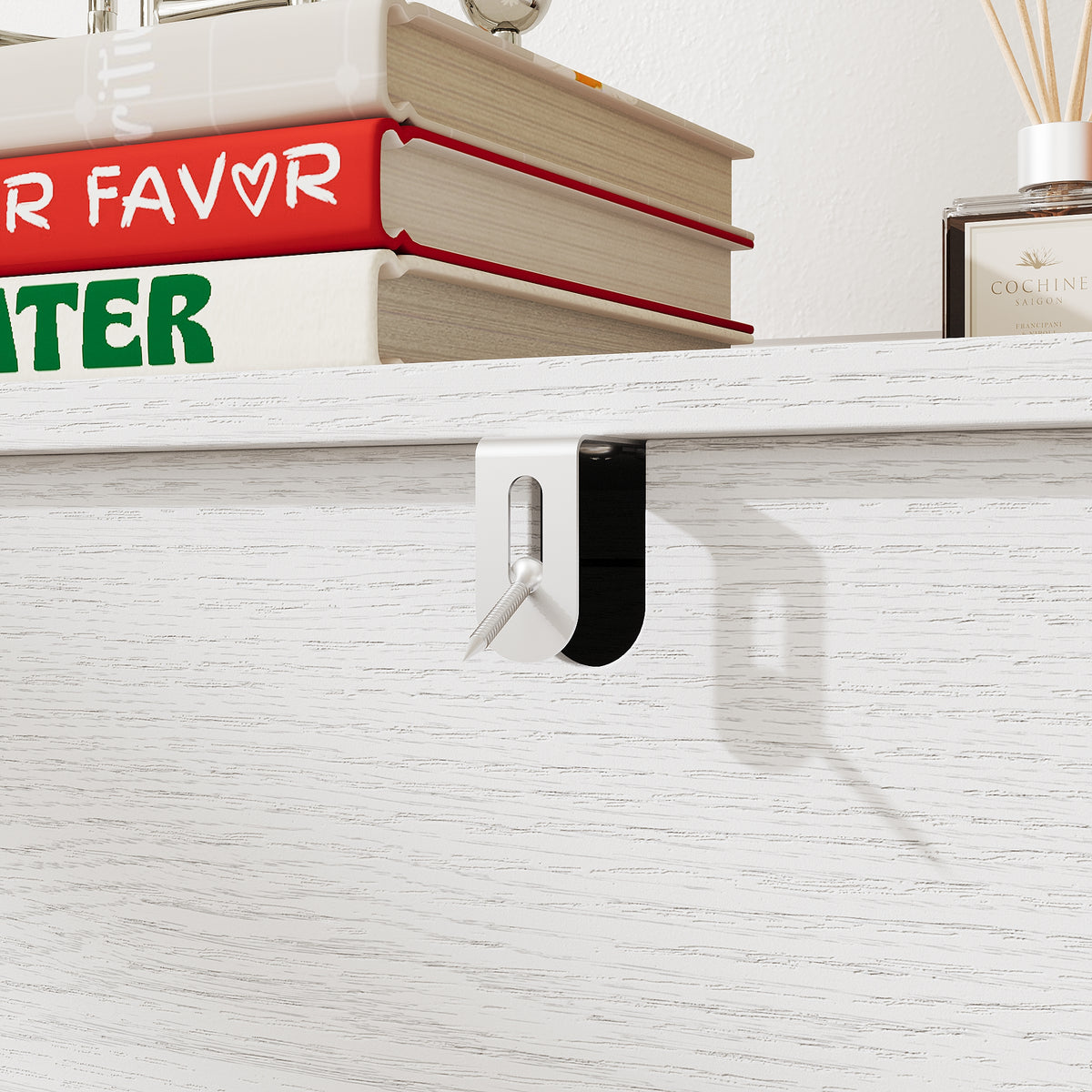 White 3-drawer nightstand with raised panel fronts and black handles
