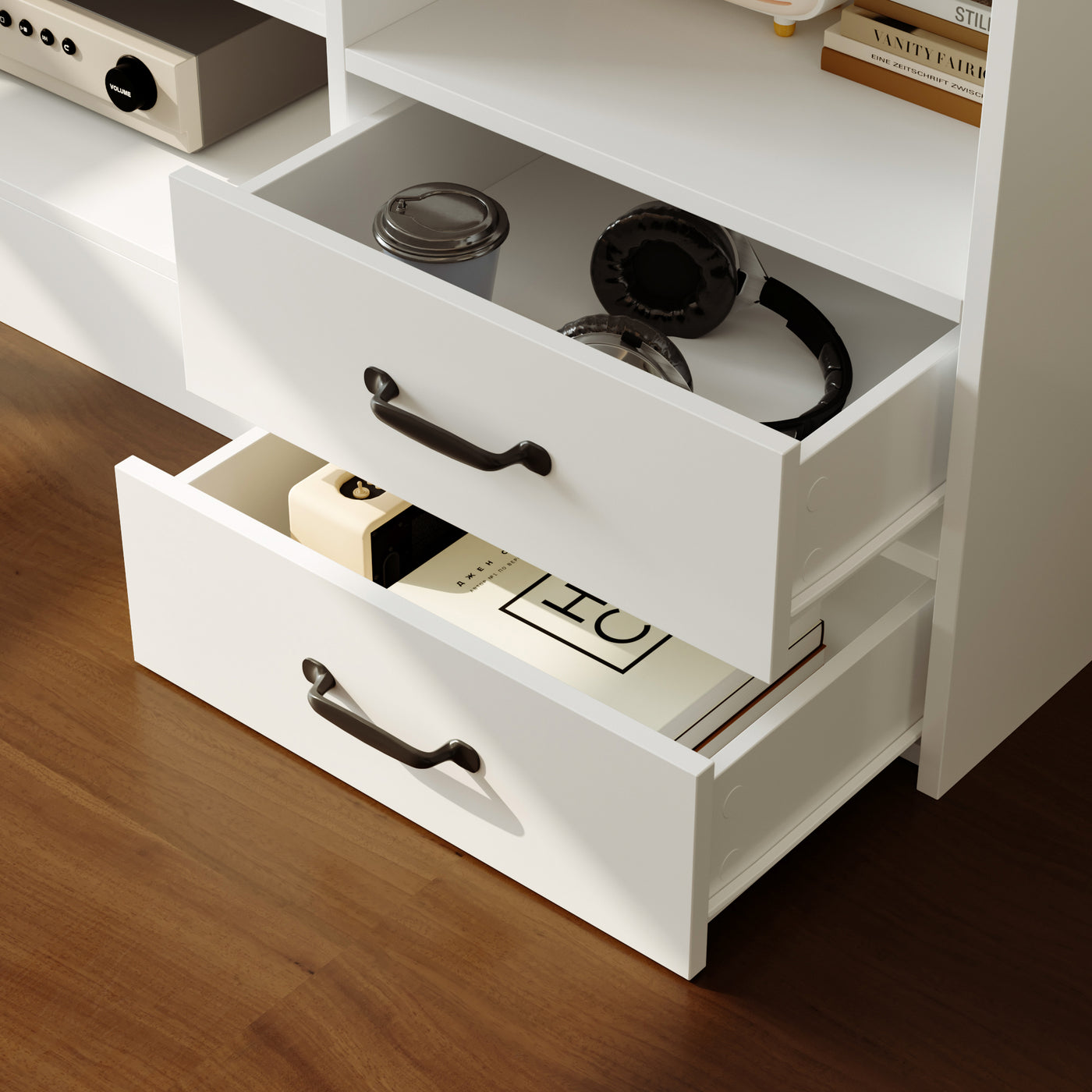 White dresser with open drawers containing electronic devices on a wooden floor.