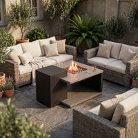 Outdoor patio with wicker furniture, fire pit, and potted plants