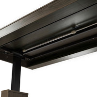 Dark wood standing desk with electric height adjustment and control panel